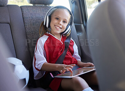 Buy stock photo Soccer, car and girl with tablet for music traveling to football practice, exercise and childrens fitness workout. Smile, sports and happy kid in headphones enjoys drive trip to training on a weekend