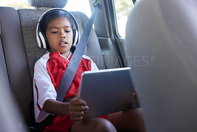 Buy stock photo Sports, car travel and relax child with tablet on journey to soccer practice while streaming video, watch movie or play online games. Transport, SUV van or kid girl using tech before football match