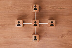 Wood, networking and communication with wooden blocks connected on a brown surface for collaboration or synergy. Matketing, teamwork and connectivity with block icons joined in partnership from above