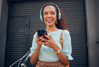 Buy stock photo Black woman, smile and phone for social media in the city with headphones in joy for 5G connection in the outdoors. Happy African female student smiling for technology or internet on smartphone