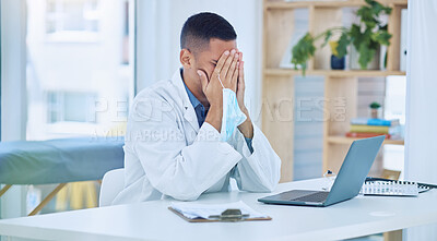 Buy stock photo Covid doctor, tired in office from stress and face mask in hand after writing report on laptop with patient information documents. Coronavirus, medical professional burnout and exhausted from covid19
