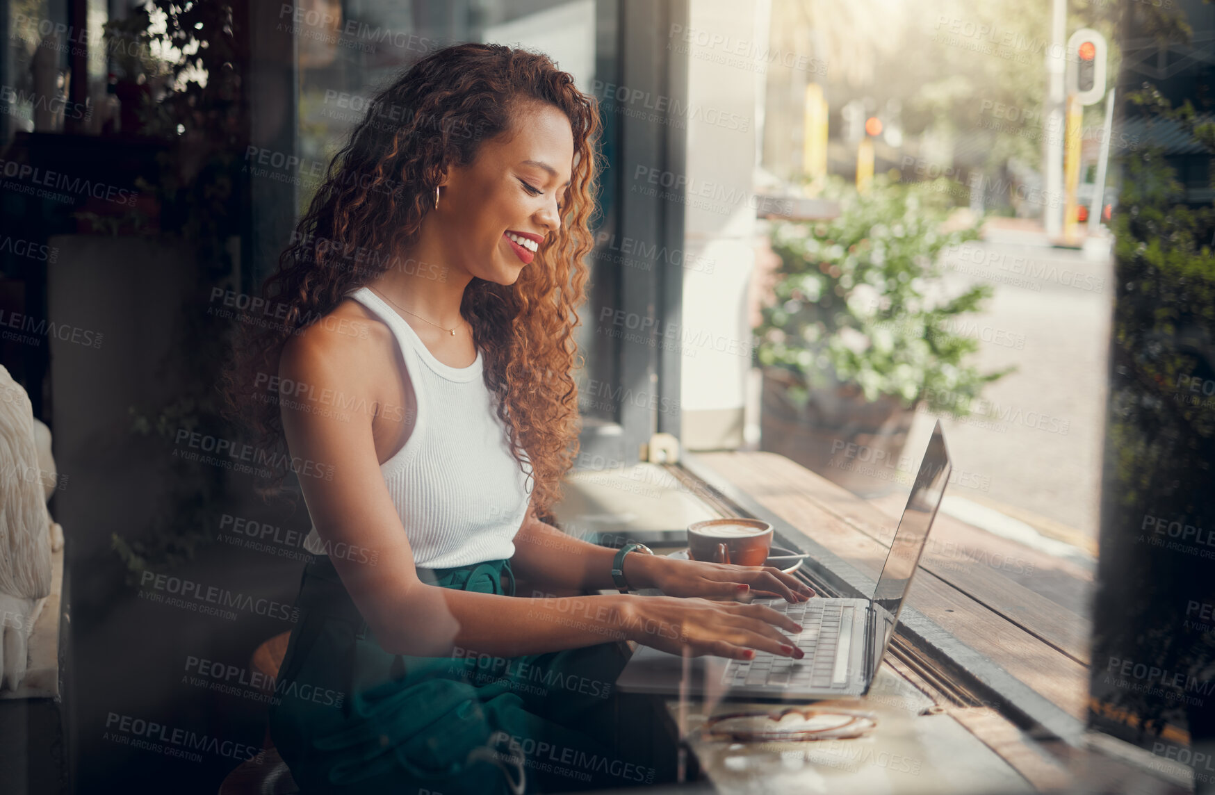 Buy stock photo Coffee, laptop, and black woman typing an email while working at a coffee shop. Happy, smile and creative African freelancer networking on the internet and writing a proposal for work on tech at cafe