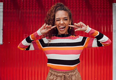 Buy stock photo Funny face, happy and black woman with a smile and tongue out with trendy fashion style against a red background. Crazy chic with comic expression while feeling silly, happy and playful outside