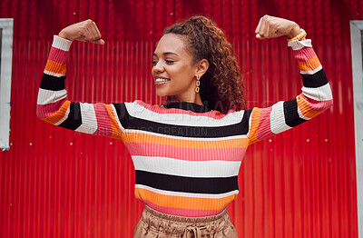 Buy stock photo Beauty, fashion and strong with a black woman flexing her muscle or bicep outdoor on a red background. Smile, proud and style with an attractive young female posing for strength or empowerment