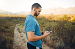 Man, phone and music earphones for fitness, training or exercise in nature environment, countryside park or grass field path. Runner, sports workout or 5g mobile technology for health data app or gps