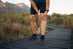 Knee pain, running and exercise in nature, man holding leg from sore joint or muscle. Training, fitness and runner exercising in woods or mountain trail with sports injury, athlete hurt after workout