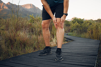 Buy stock photo Knee pain, running and exercise in nature, man holding leg from sore joint or muscle. Training, fitness and runner exercising in woods or mountain trail with sports injury, athlete hurt after workout