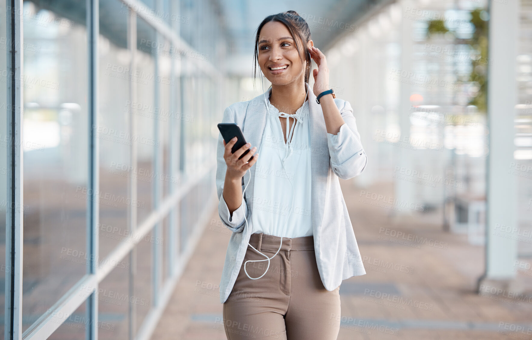 Buy stock photo Earphones, phone and business woman in city streaming audio, podcast or music. Smile, relax and female from India walking, on break or 5g mobile app listening to radio sound track on street outdoors
