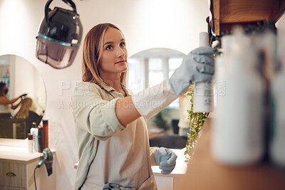 Buy stock photo Woman, shelf and salon while looking at product, shampoo and spray at work in hair care, beauty and packing. Small business owner, hairdresser and entrepreneur in store, startup and arrange cosmetics