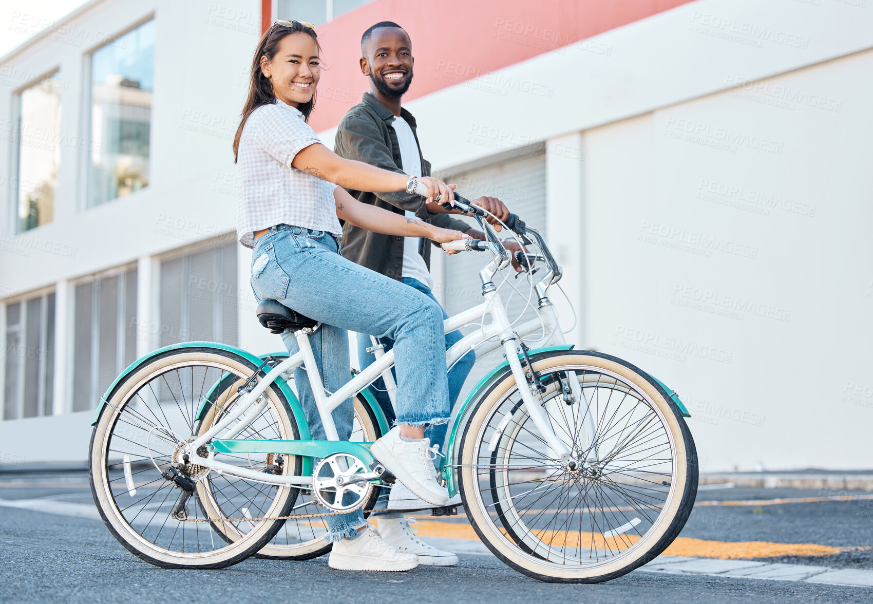 Buy stock photo Happy couple, bicycle and city street travel for exercise, fun or adventure outdoor. Black and asian tourist man and woman cycling for carbon footprint on bike in urban town traveling in South Africa