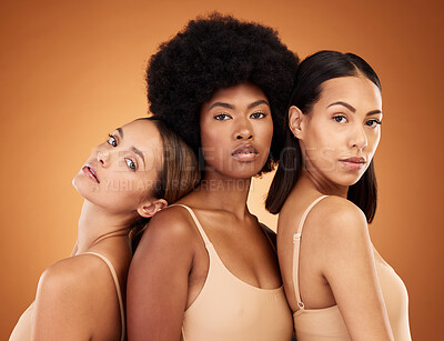 Buy stock photo Diversity, skincare and beauty with model woman friends in studio on a brown background for inclusion. Health, luxury and portrait the a female group standing together for wellness or healthy skin
