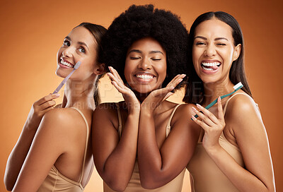 Buy stock photo Beauty, smile and dental with women and toothbrush for teeth, oral healthcare and hygiene. Orthodontics, lifestyle and diversity with girls against orange background for wellness, clean or dentistry