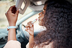 Woman, car mirror and lipstick makeup touch up on business road trip, travel or vacation. African American girl, beauty lifestyle and glamour in transportation for before work  or corporate event 
