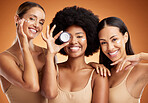 Beauty, skincare and portrait of women with smile in studio with face cream or moisturizer. Happiness, diversity and friends with facial routine for cosmetics, health and wellness by brown background