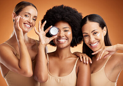 Buy stock photo Beauty, skincare and portrait of women with smile in studio with face cream or moisturizer. Happiness, diversity and friends with facial routine for cosmetics, health and wellness by brown background
