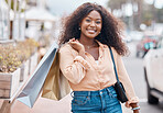 Black woman, shopping and bags with smile in the city for sale, discount and urban outdoors. Portrait of happy African American female shopper holding gifts smiling in happiness for town market