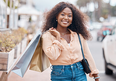 Buy stock photo Black woman, shopping and bags with smile in the city for sale, discount and urban outdoors. Portrait of happy African American female shopper holding gifts smiling in happiness for town market