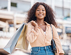 Happy, city and black woman shopping for fashion, customer discount deals and clothes sales offer with freedom. Smile, portrait and excited shopper with urban retail clothing bags from boutique store