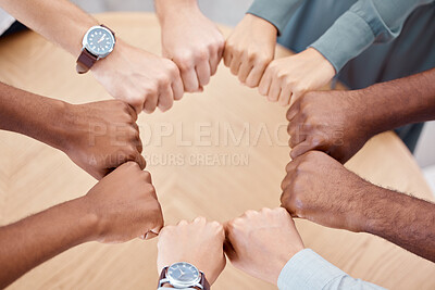 Buy stock photo Circle, fist and diversity for solidarity, above and teamwork in office for power, unity and collaboration at table. Group, job and hands in workforce, team and staff for goal, motivation or mission