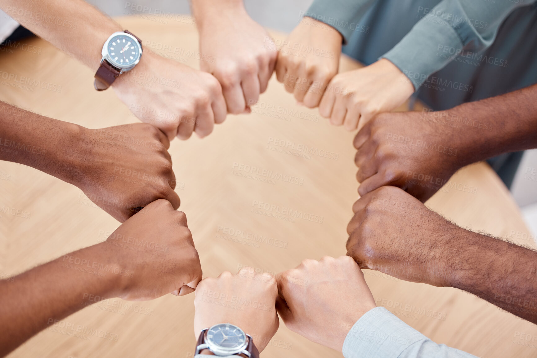 Buy stock photo Circle, fist and diversity for solidarity, above and teamwork in office for power, unity and collaboration at table. Group, job and hands in workforce, team and staff for goal, motivation or mission