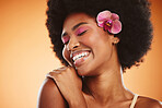 Beauty, smile and cosmetic makeup smile of a black woman with an orchid looking happy. Natural hair, calm and cosmetics of a person from Jamaica feeling beautiful, relax and happiness in her skin