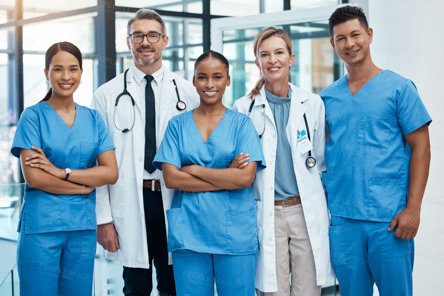 Buy stock photo Happy doctors and nurse smile at a hospital with support, teamwork and collaboration with diversity. Team of expert medical professionals smiling at work together at clinic in the healthcare industry