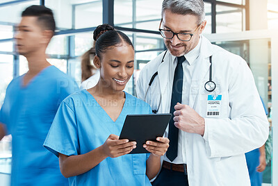 Buy stock photo Diversity, doctor and nurse on a tablet planning a surgery strategy or talking about medical results in a hospital. Teamwork, collaboration and happy healthcare workers speaking and reading a report 