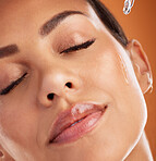 Oil, skincare and woman with product for facial health against an orange studio background. Face of a model with a liquid serum for beauty, cleaning of skin and essential oil from dermatology