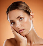 Skincare, portrait and woman with face makeup for beauty against an orange studio background. Young girl model with wellness from a spa, dermatology facial care and cosmetics for health of body