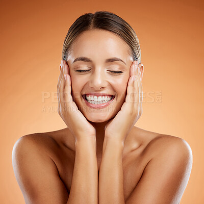 Skincare, beauty and woman excited about face makeup against mockup orange studio background. Happy, smile and young girl model with facial cosmetics and wellness from dermatology with mock up space