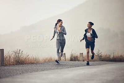 Running, fitness and exercise with a sports woman friends on a road or street for cardio training in the morning. Workout, health and endurance with a female runner and friend in the mountains