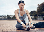 Fitness, sports and woman with shoes ready to start running outdoors for exercise, raining and cardio workout. Young, tying and healthy girl runner with preparing footwear laces for marathon training