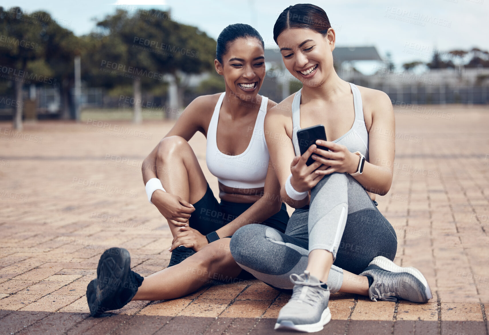 Buy stock photo Friends, fitness app and phone of happy women on internet for social media, motivation message or exercise goal. Female runner or athlete with smartphone on training break and cardio workout outside 