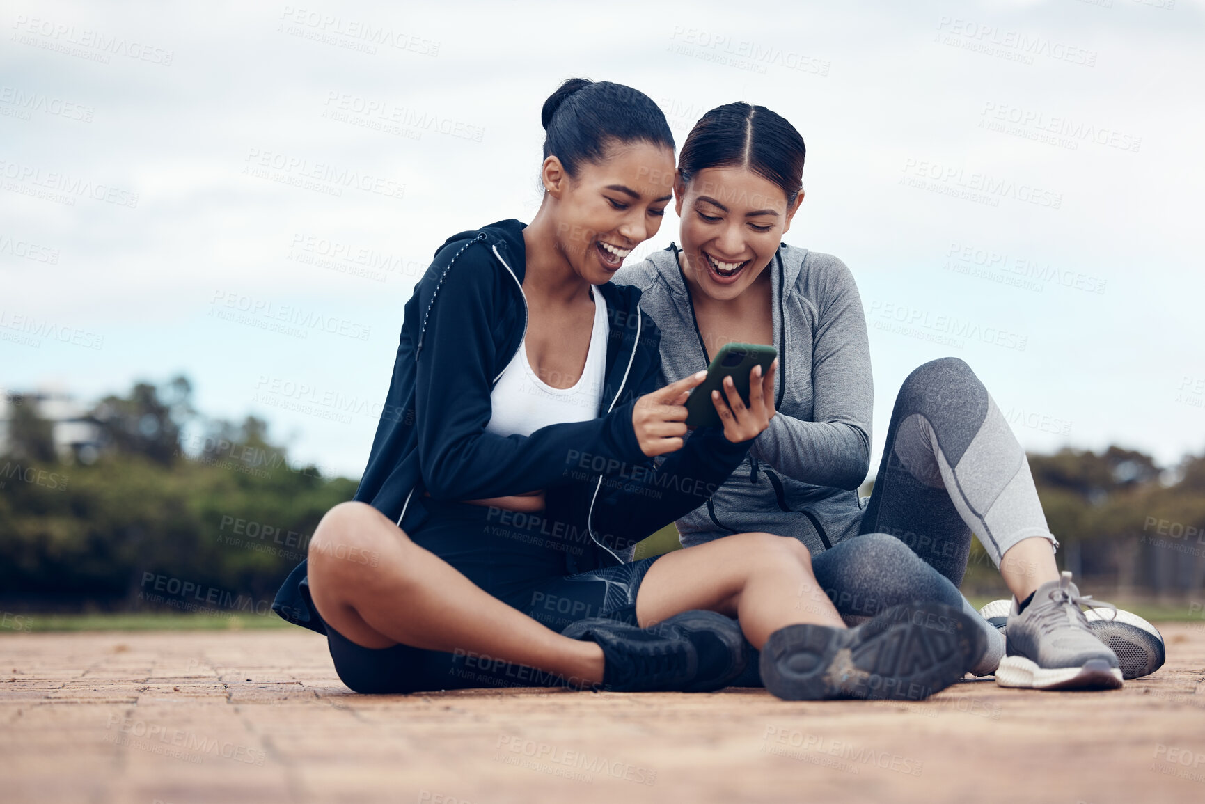 Buy stock photo Phone, happy and fitness friends on social media laughing at funny gossip, fake news and trending viral online content. Women, sports and healthy girls resting for training workout exercise outdoors