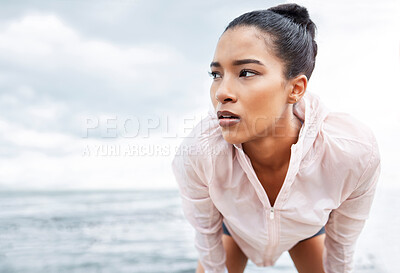 Buy stock photo Fitness, break and running with a sports woman tired outdoor by the ocean after a workout. Training, exhausted and exercise with a young female athlete exercising alone on the beach by the ocean