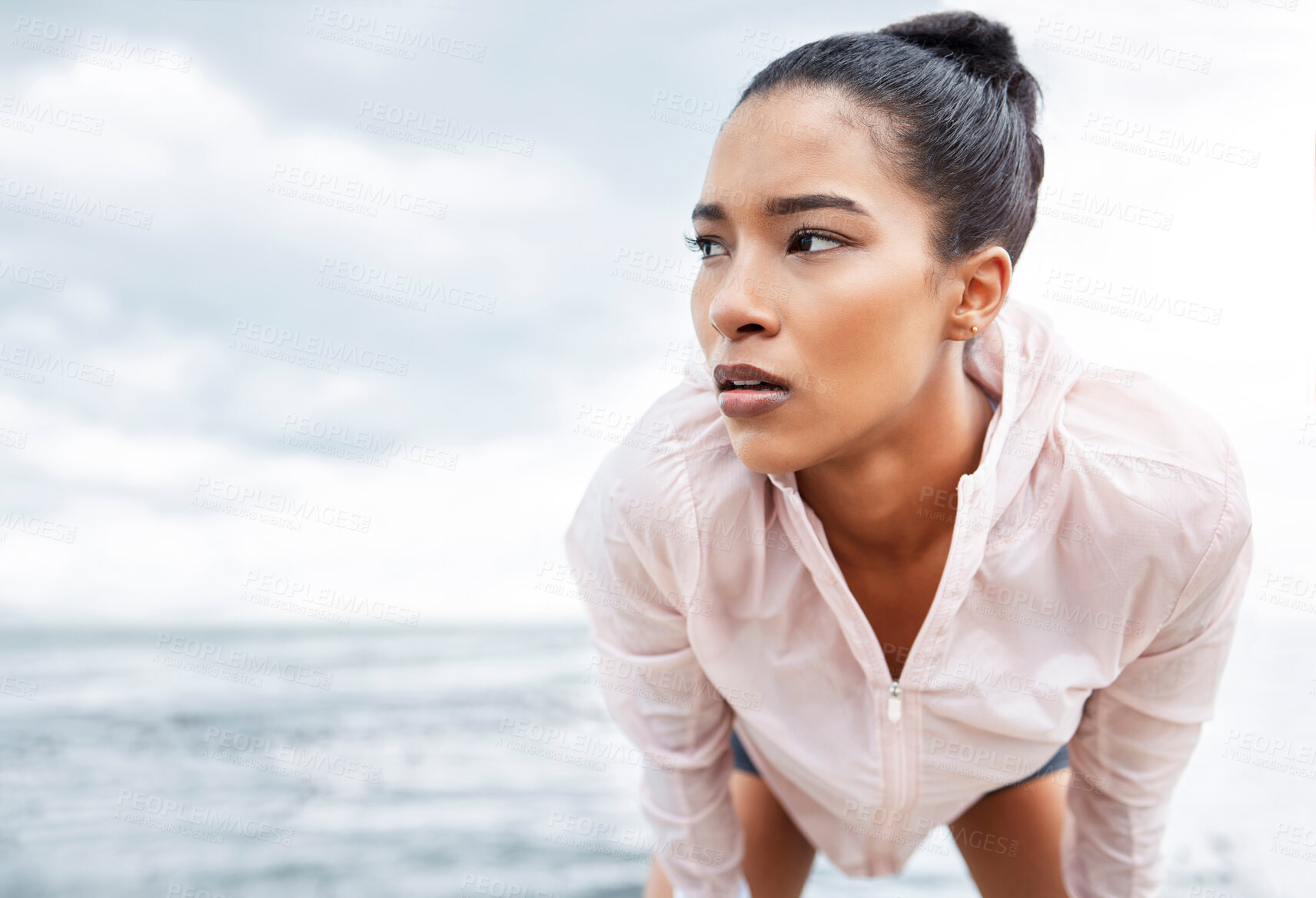 Buy stock photo Fitness, break and running with a sports woman tired outdoor by the ocean after a workout. Training, exhausted and exercise with a young female athlete exercising alone on the beach by the ocean