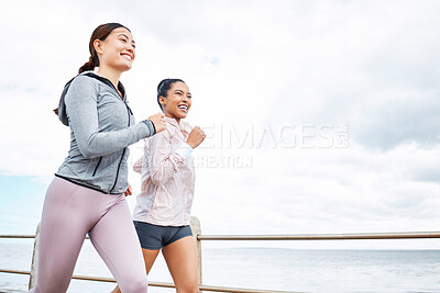 Buy stock photo Friends, women and running by ocean, sea or promenade for wellness, fitness and health. Diversity, exercise and happy girls out for a run, cardio workout or training together outdoors by seashore.
