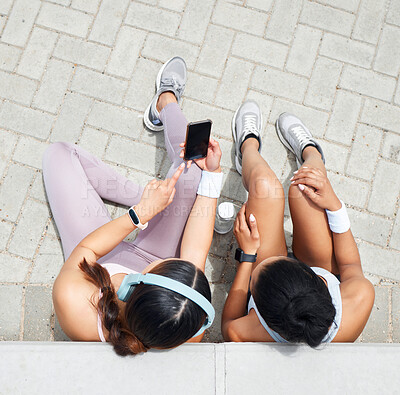 Buy stock photo Women in city, online workout app in Miami and healthy friends relax sitting on urban floor watching fitness video. Girl streaming audio podcast, show social media exercise and outdoor 5g technology