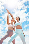 Pilates, personal trainer and woman client learning wellness, support and workout exercise accountability or trust on blue sky clouds. Stretching people, mentor or coach training with sun lens flare