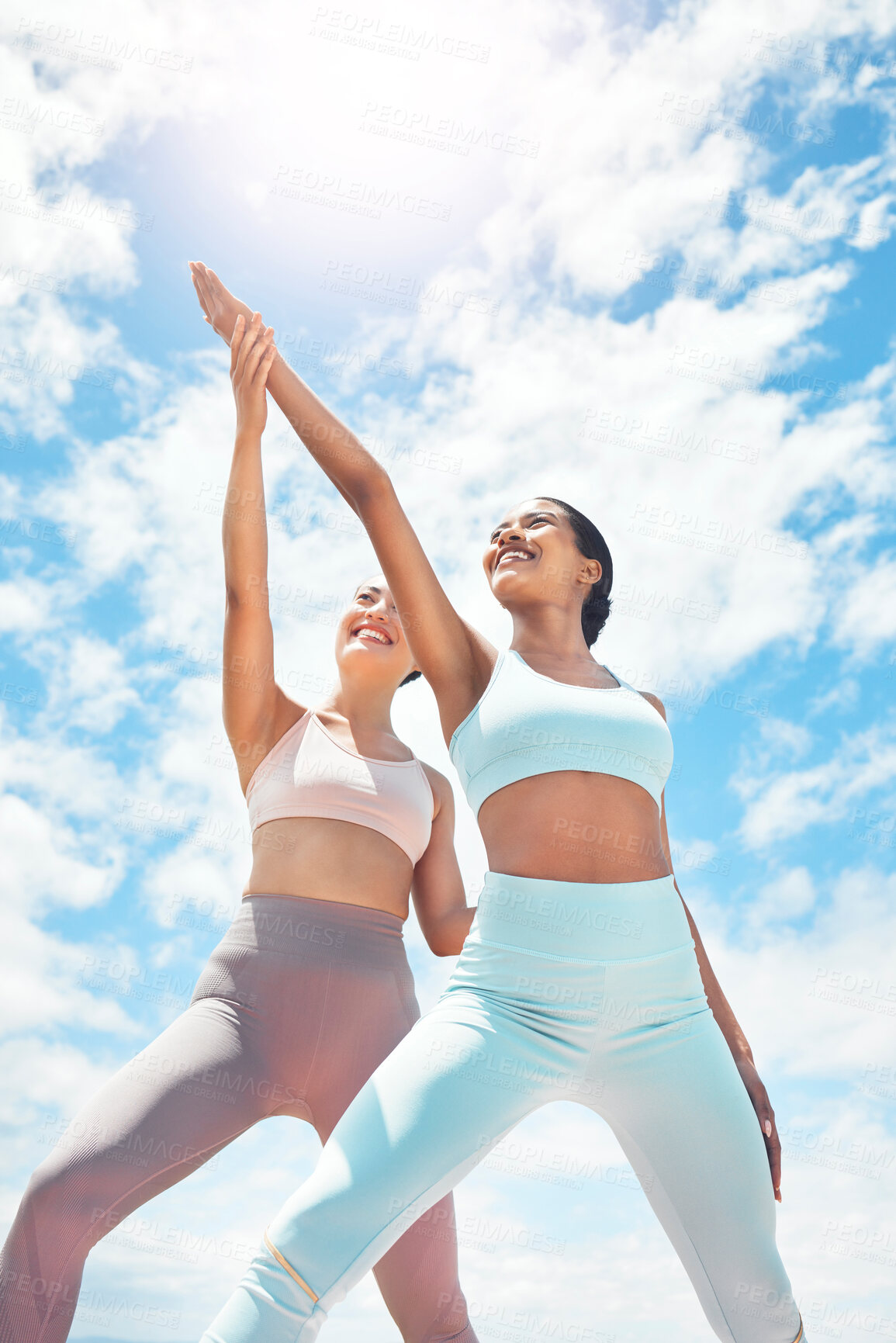 Buy stock photo Pilates, personal trainer and woman client learning wellness, support and workout exercise accountability or trust on blue sky clouds. Stretching people, mentor or coach training with sun lens flare