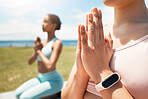 Hands, meditation and smartwatch by friends doing yoga on field for fitness, health and peace with balance. Zen, training and cardio tracking on watch with women in yoga pose, bonding and meditating