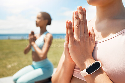 Buy stock photo Hands, meditation and smartwatch by friends doing yoga on field for fitness, health and peace with balance. Zen, training and cardio tracking on watch with women in yoga pose, bonding and meditating