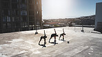 Fitness group, stretching and ball sports with friends doing exercise, workout and warm up on city building rooftop on a summer day. Athlete man and women during soccer training or football practice