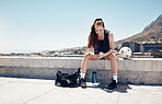 Sports woman, phone and football or soccer workout on rooftop of city building take break or rest using 5g network service for fitness app or social media. Female athlete after exercising with a ball