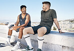 Friends, sports and talking after soccer game on rooftop for urban sports, exercise and training outdoor in summer. Athlete men have conversation about fitness, football and city lifestyle with ball