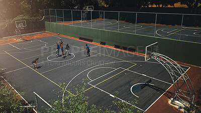 Buy stock photo Basketball, outdoor court and athlete men showing energy in ball sports competition or game for fitness and training. Above view, exercise and sport with community people playing streetball together
