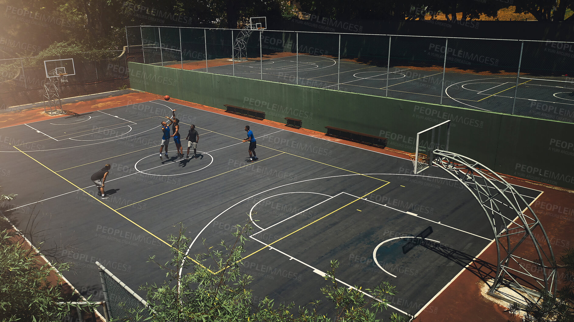 Buy stock photo Basketball, outdoor court and athlete men showing energy in ball sports competition or game for fitness and training. Above view, exercise and sport with community people playing streetball together