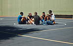Teamwork, basketball and planning with friends relax on sports court for training, workout and fitness together. Exercise, goals and health with athlete men relax after game competition in outdoor