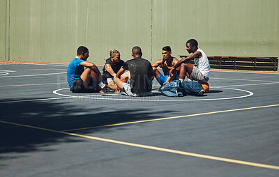 Buy stock photo Teamwork, basketball and planning with friends relax on sports court for training, workout and fitness together. Exercise, goals and health with athlete men relax after game competition in outdoor