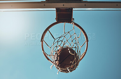 Buy stock photo Basketball, net and ball below in sports game outdoors for sports match in the USA. Sport and airball of throw to score point for win, victory against fiberglass board with blue sky background
